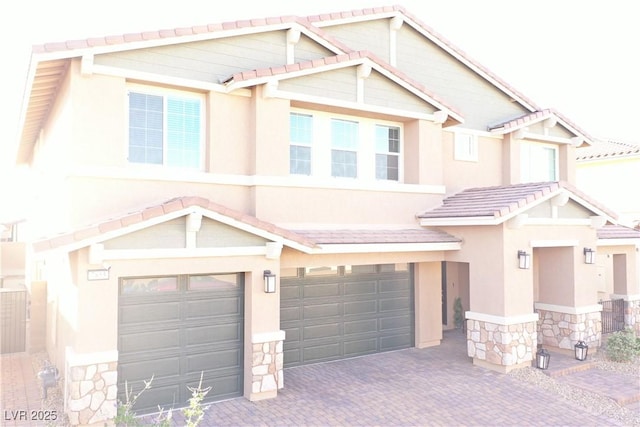 7855 Skyler Falls Ln, North Las Vegas, NV 89084 - multi unit property featuring an attached garage, stone siding, a tile roof, and stucco siding
