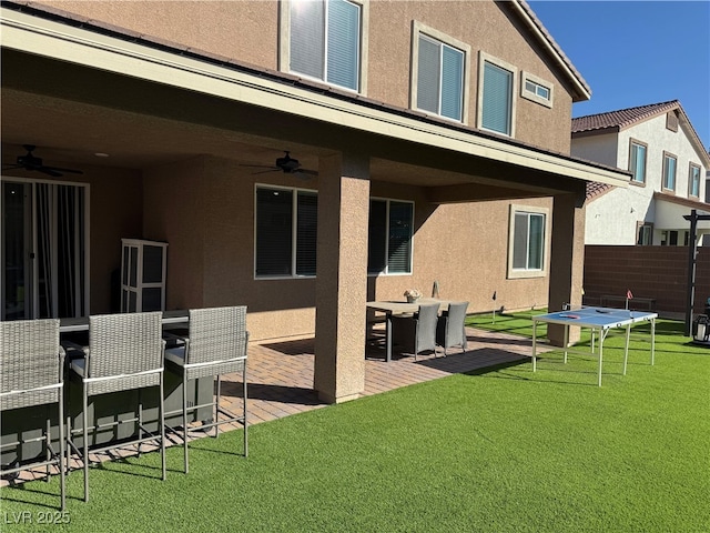 7855 Skyler Falls Ln, North Las Vegas, NV 89084 - rear view of property with a ceiling fan, stucco siding, a patio area, and outdoor dining area