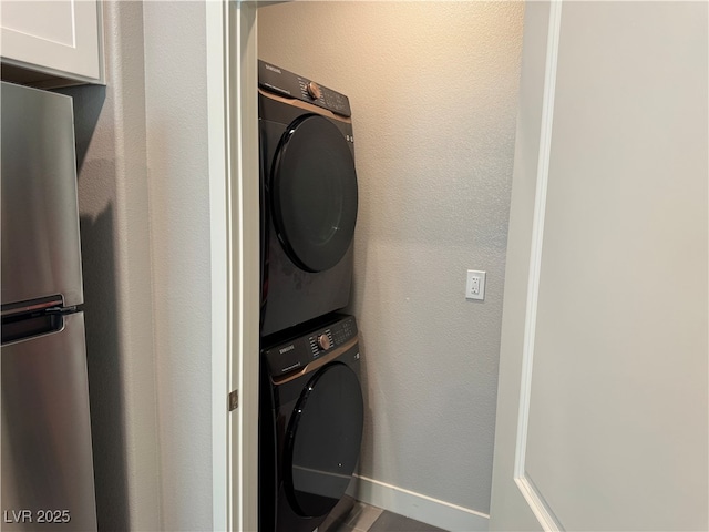 7855 Skyler Falls Ln, North Las Vegas, NV 89084 - washroom featuring stacked washer / dryer and baseboards