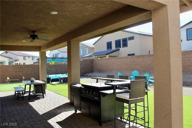 7855 Skyler Falls Ln, North Las Vegas, NV 89084 - fenced backyard featuring a patio area, outdoor dining area, ceiling fan, and an outdoor living space