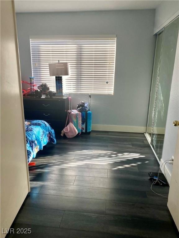 1482 Flintrock Rd, Henderson, NV 89014 - unfurnished bedroom featuring wood finished floors, baseboards, and a closet