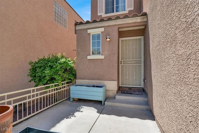 6581 Netherseal Ave, Las Vegas, NV 89139 - view of exterior entry with stucco siding and a tiled roof