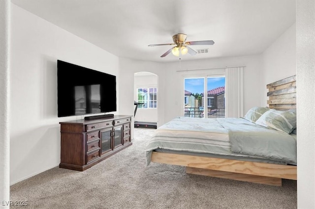 6581 Netherseal Ave, Las Vegas, NV 89139 - bedroom with access to outside, arched walkways, carpet, and ceiling fan