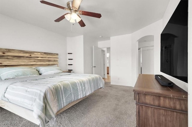 6581 Netherseal Ave, Las Vegas, NV 89139 - carpeted bedroom featuring arched walkways and a ceiling fan