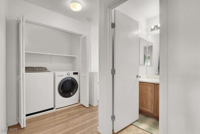6581 Netherseal Ave, Las Vegas, NV 89139 - laundry room with washing machine and dryer, light wood-type flooring, and baseboards