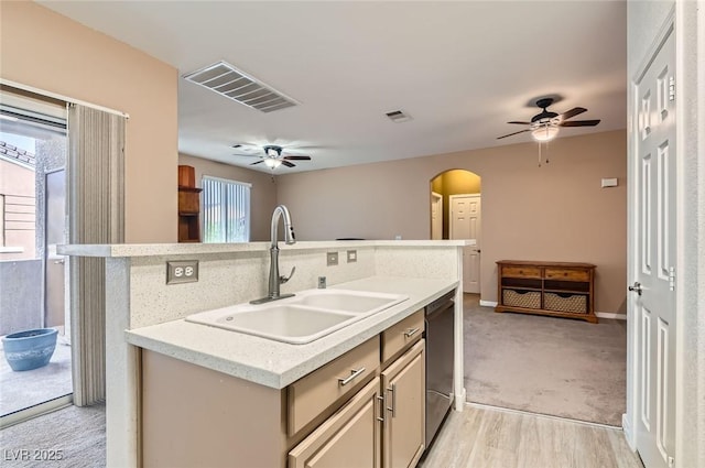 9303 Gilcrease Ave Unit 1002, Las Vegas, NV 89149 - kitchen with a ceiling fan, a sink, arched walkways, a center island with sink, and light colored carpet