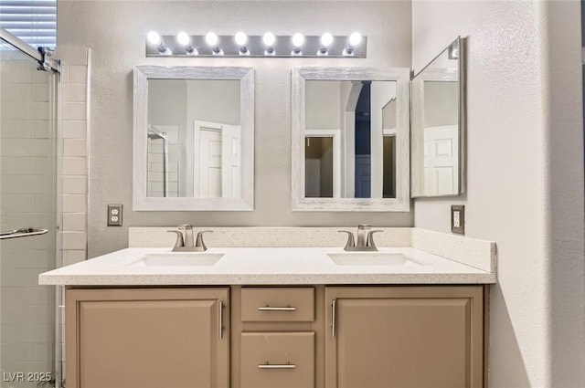 9303 Gilcrease Ave Unit 1002, Las Vegas, NV 89149 - bathroom featuring double vanity, a tile shower, and a textured wall