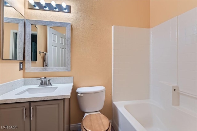 9303 Gilcrease Ave Unit 1002, Las Vegas, NV 89149 - full bath with toilet, vanity, tub / shower combination, and a textured wall