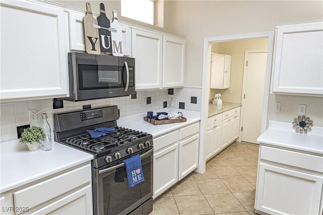 2501 Maddington Dr, Las Vegas, NV 89134 - kitchen featuring stainless steel appliances, tasteful backsplash, white cabinetry, light countertops, and light tile patterned flooring