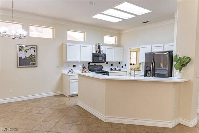 2501 Maddington Dr, Las Vegas, NV 89134 - kitchen featuring stainless steel microwave, refrigerator with ice dispenser, stove, crown molding, and a chandelier
