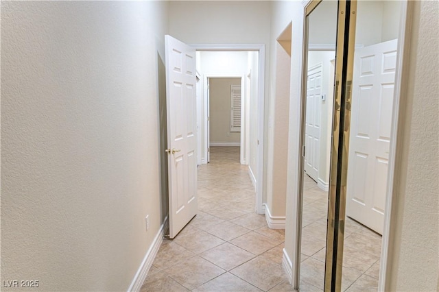 2501 Maddington Dr, Las Vegas, NV 89134 - hall featuring a textured wall, light tile patterned flooring, and baseboards