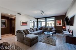 8925 W Flamingo Rd Unit 117, Las Vegas, NV 89147 - living room featuring wood finished floors and track lighting