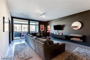 8925 W Flamingo Rd Unit 117, Las Vegas, NV 89147 - living area featuring rail lighting and wood finished floors