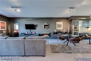 8925 W Flamingo Rd Unit 117, Las Vegas, NV 89147 - living room featuring rail lighting