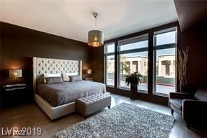 8925 W Flamingo Rd Unit 117, Las Vegas, NV 89147 - bedroom with access to exterior and wood finished floors