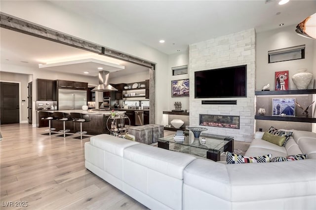 787 Keyland St, Las Vegas, NV 89138 - living area featuring light wood finished floors, a fireplace, and recessed lighting