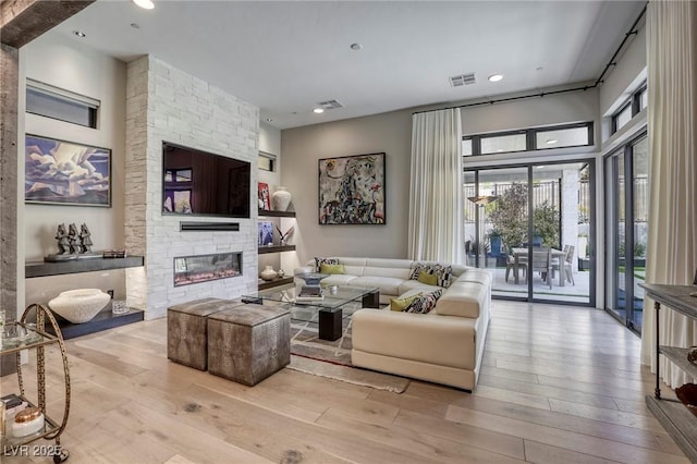 787 Keyland St, Las Vegas, NV 89138 - living room featuring hardwood / wood-style floors and a stone fireplace
