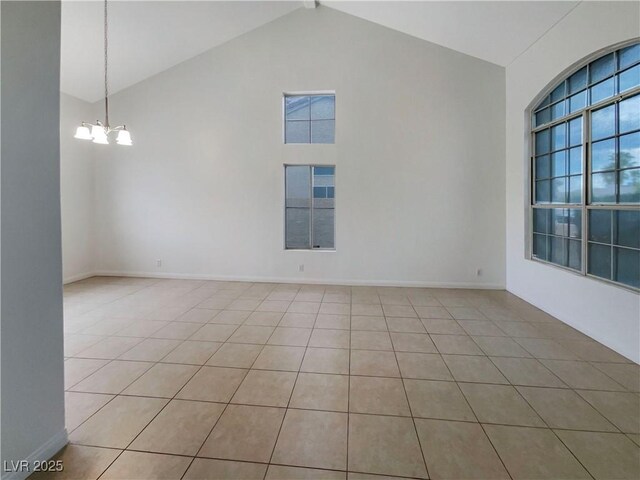 6120 Desert Haven Rd, Las Vegas, NV 89130 - unfurnished room with a chandelier, light tile patterned floors, high vaulted ceiling, and baseboards