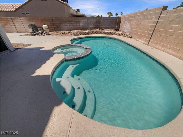 6120 Desert Haven Rd, Las Vegas, NV 89130 - view of swimming pool with a pool with connected hot tub, a fenced backyard, and a patio area