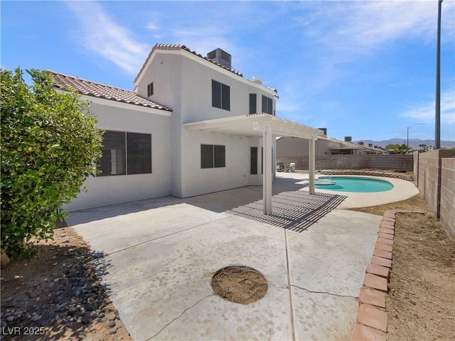 6120 Desert Haven Rd, Las Vegas, NV 89130 - back of property with a fenced backyard, stucco siding, a pergola, a tiled roof, and a patio