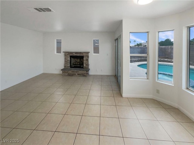 6120 Desert Haven Rd, Las Vegas, NV 89130 - unfurnished living room featuring a stone fireplace and light tile patterned floors