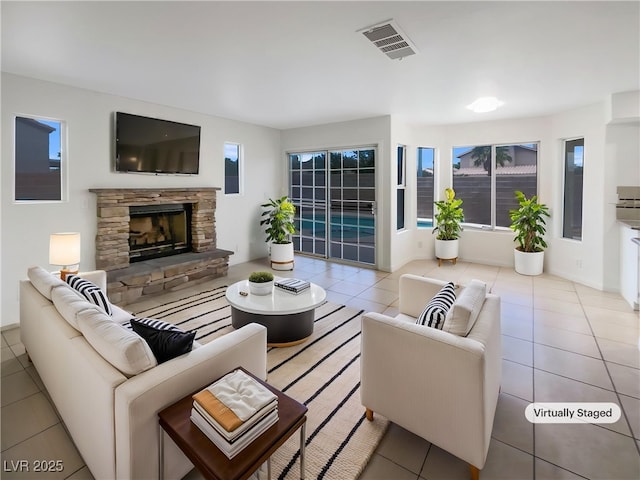 6120 Desert Haven Rd, Las Vegas, NV 89130 - tiled living room featuring a fireplace and plenty of natural light