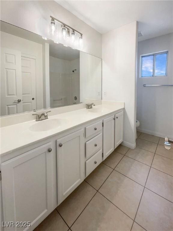 6120 Desert Haven Rd, Las Vegas, NV 89130 - bathroom with tile patterned floors, double vanity, baseboards, toilet, and a shower
