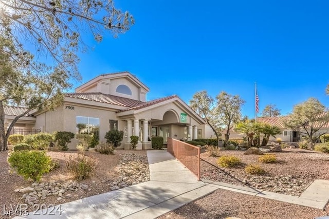 7912 Foxwood Pl Unit 104, Las Vegas, NV 89145 - mediterranean / spanish house featuring stucco siding, a tiled roof, and covered porch