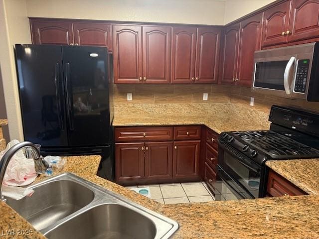 7912 Foxwood Pl Unit 104, Las Vegas, NV 89145 - kitchen featuring black appliances, a sink, dark brown cabinets, light tile patterned floors, and light stone countertops