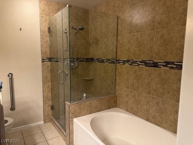 7912 Foxwood Pl Unit 104, Las Vegas, NV 89145 - bathroom featuring a shower stall, a bath, tile patterned floors, and toilet