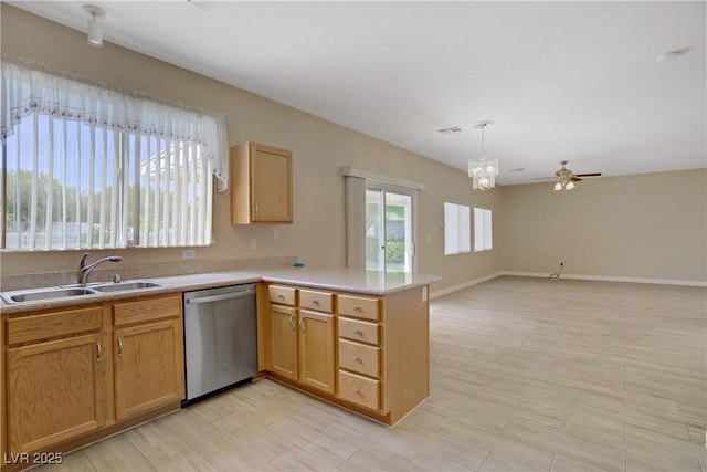 8913 Loggers Mill Ave, Las Vegas, NV 89143 - kitchen with stainless steel dishwasher, a sink, a peninsula, a ceiling fan, and light countertops