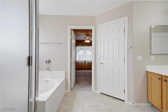 8913 Loggers Mill Ave, Las Vegas, NV 89143 - ensuite bathroom with a bath, vanity, and baseboards