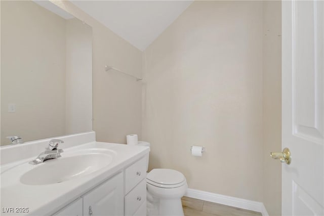 8913 Loggers Mill Ave, Las Vegas, NV 89143 - bathroom featuring toilet, vanity, and baseboards