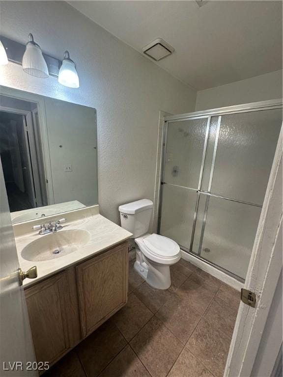 227 N Lamb Blvd Unit A, Las Vegas, NV 89110 - bathroom with a shower stall, vanity, toilet, and tile patterned floors