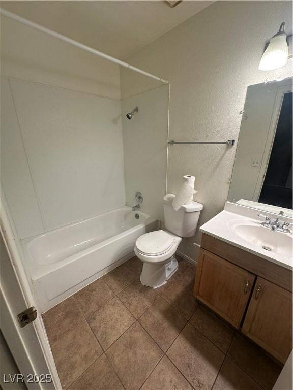 227 N Lamb Blvd Unit A, Las Vegas, NV 89110 - bathroom with toilet, tub / shower combination, vanity, tile patterned floors, and baseboards