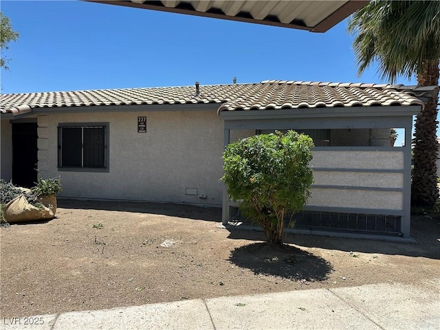 227 N Lamb Blvd Unit A, Las Vegas, NV 89110 - view of side of property with a tile roof and stucco siding