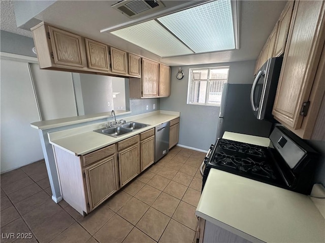 227 N Lamb Blvd Unit A, Las Vegas, NV 89110 - kitchen featuring stainless steel appliances, a sink, light tile patterned floors, light countertops, and baseboards