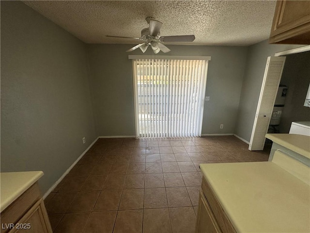 227 N Lamb Blvd Unit A, Las Vegas, NV 89110 - unfurnished dining area with ceiling fan, tile patterned floors, baseboards, and a textured ceiling