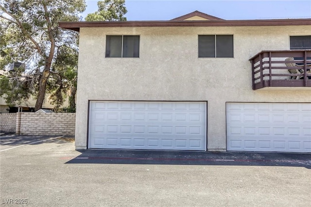 2349 Wooster Cir Unit A, Las Vegas, NV 89108 - view of front facade featuring stucco siding, a balcony, and a garage