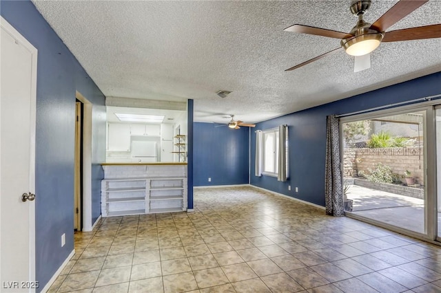2349 Wooster Cir Unit A, Las Vegas, NV 89108 - unfurnished living room with ceiling fan, a textured ceiling, baseboards, and tile patterned flooring