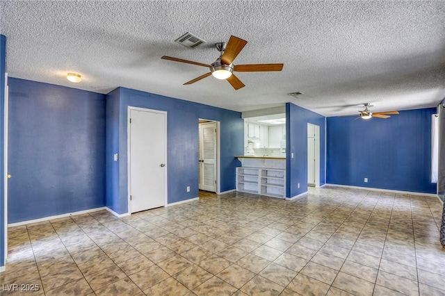 2349 Wooster Cir Unit A, Las Vegas, NV 89108 - unfurnished living room featuring a ceiling fan, a textured ceiling, tile patterned flooring, and baseboards