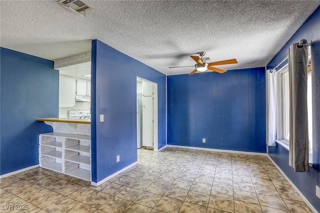 2349 Wooster Cir Unit A, Las Vegas, NV 89108 - unfurnished living room featuring ceiling fan, a textured ceiling, baseboards, and tile patterned flooring