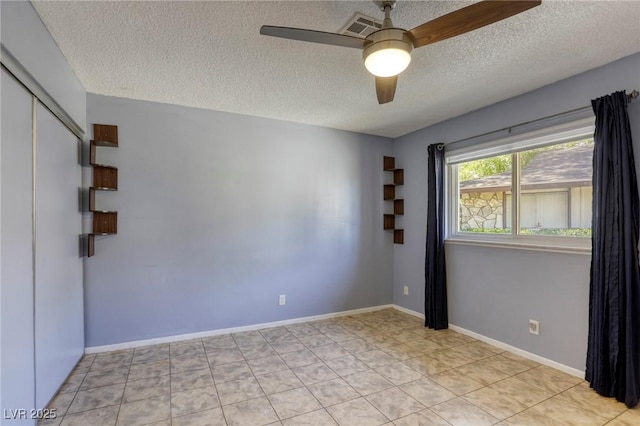 2349 Wooster Cir Unit A, Las Vegas, NV 89108 - tiled spare room featuring a textured ceiling, ceiling fan, and baseboards