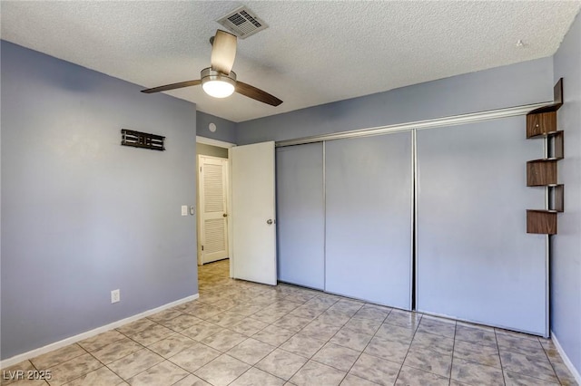 2349 Wooster Cir Unit A, Las Vegas, NV 89108 - unfurnished bedroom featuring a textured ceiling, a closet, ceiling fan, baseboards, and light tile patterned floors