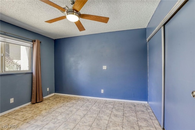2349 Wooster Cir Unit A, Las Vegas, NV 89108 - unfurnished bedroom with a textured ceiling, a closet, light tile patterned floors, ceiling fan, and baseboards