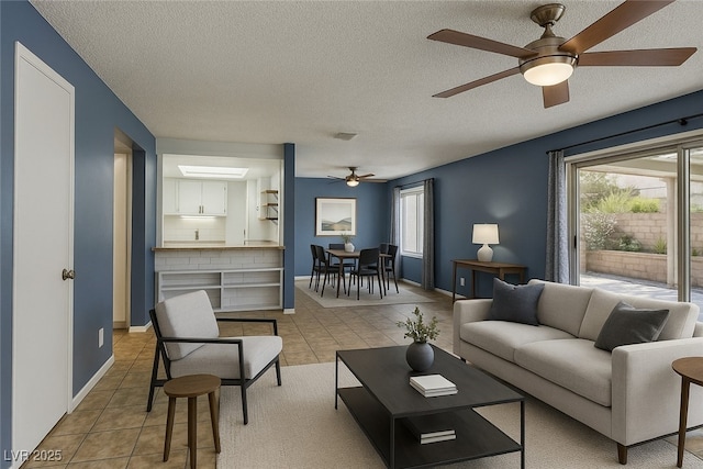 2349 Wooster Cir Unit A, Las Vegas, NV 89108 - living room with a ceiling fan, a textured ceiling, plenty of natural light, and light tile patterned flooring