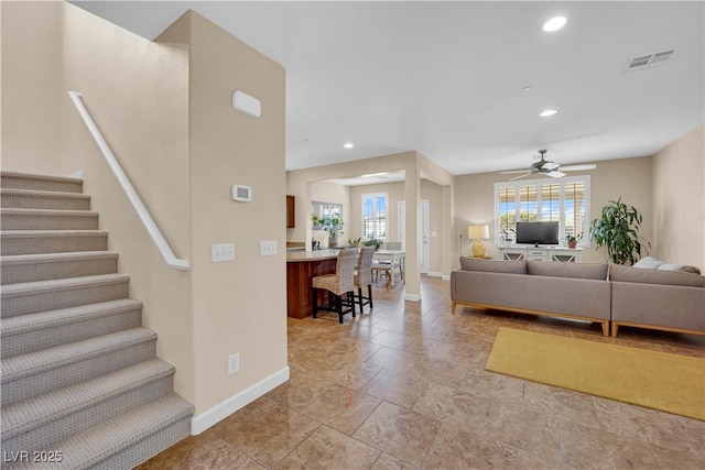 1104 Aspen Cliff Dr, Henderson, NV 89011 - living room featuring baseboards, stairway, a ceiling fan, healthy amount of natural light, and recessed lighting