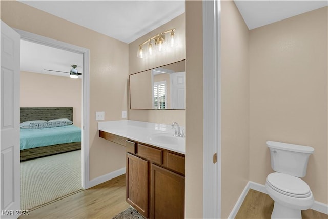 1104 Aspen Cliff Dr, Henderson, NV 89011 - ensuite bathroom with wood finished floors, toilet, baseboards, and vanity
