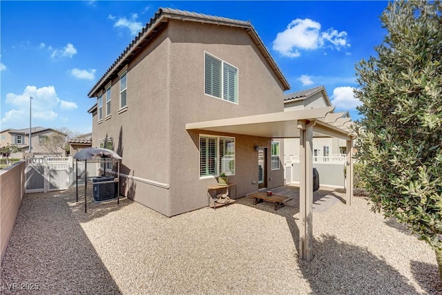 1104 Aspen Cliff Dr, Henderson, NV 89011 - rear view of property featuring stucco siding, a patio area, a fenced backyard, and a tile roof