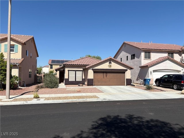 8237 Cline Mountain St, Las Vegas, NV 89131 - mediterranean / spanish house featuring an attached garage, concrete driveway, stucco siding, and a tiled roof